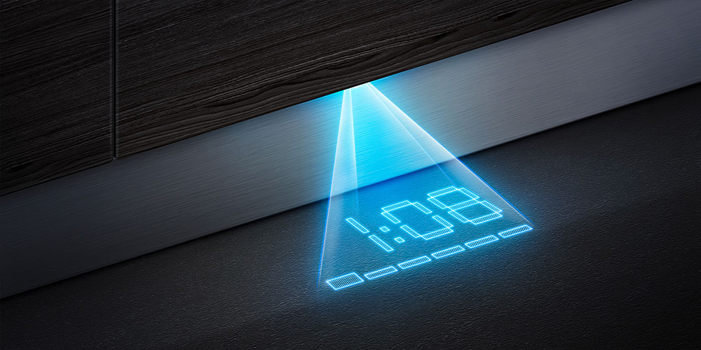 Wyświetlacz czasu zmywarki rzutowany niebieskim światłem na podłogę.